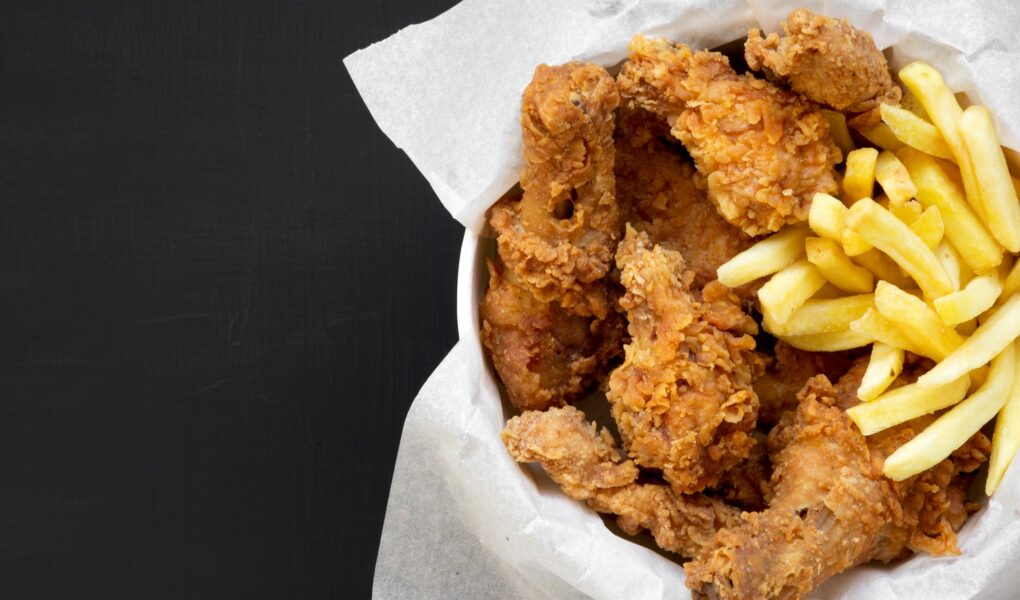 Fried chicken legs, spicy wings, French fries and chicken fingers