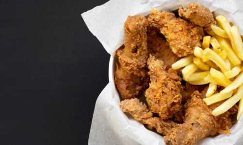 Fried chicken legs, spicy wings, French fries and chicken fingers