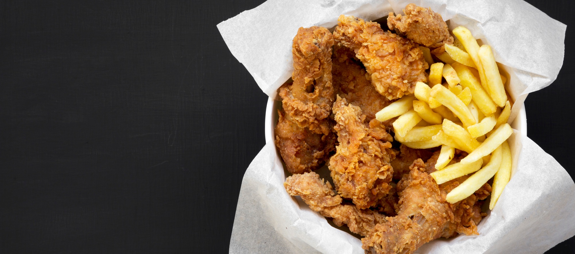 Fried chicken legs, spicy wings, French fries and chicken fingers
