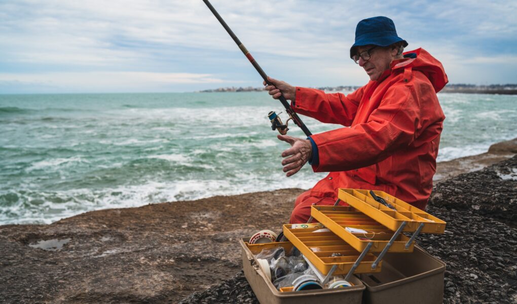 Old man fishing in the sea.
