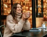 Stylish young woman drinking coffee at the coffee shop